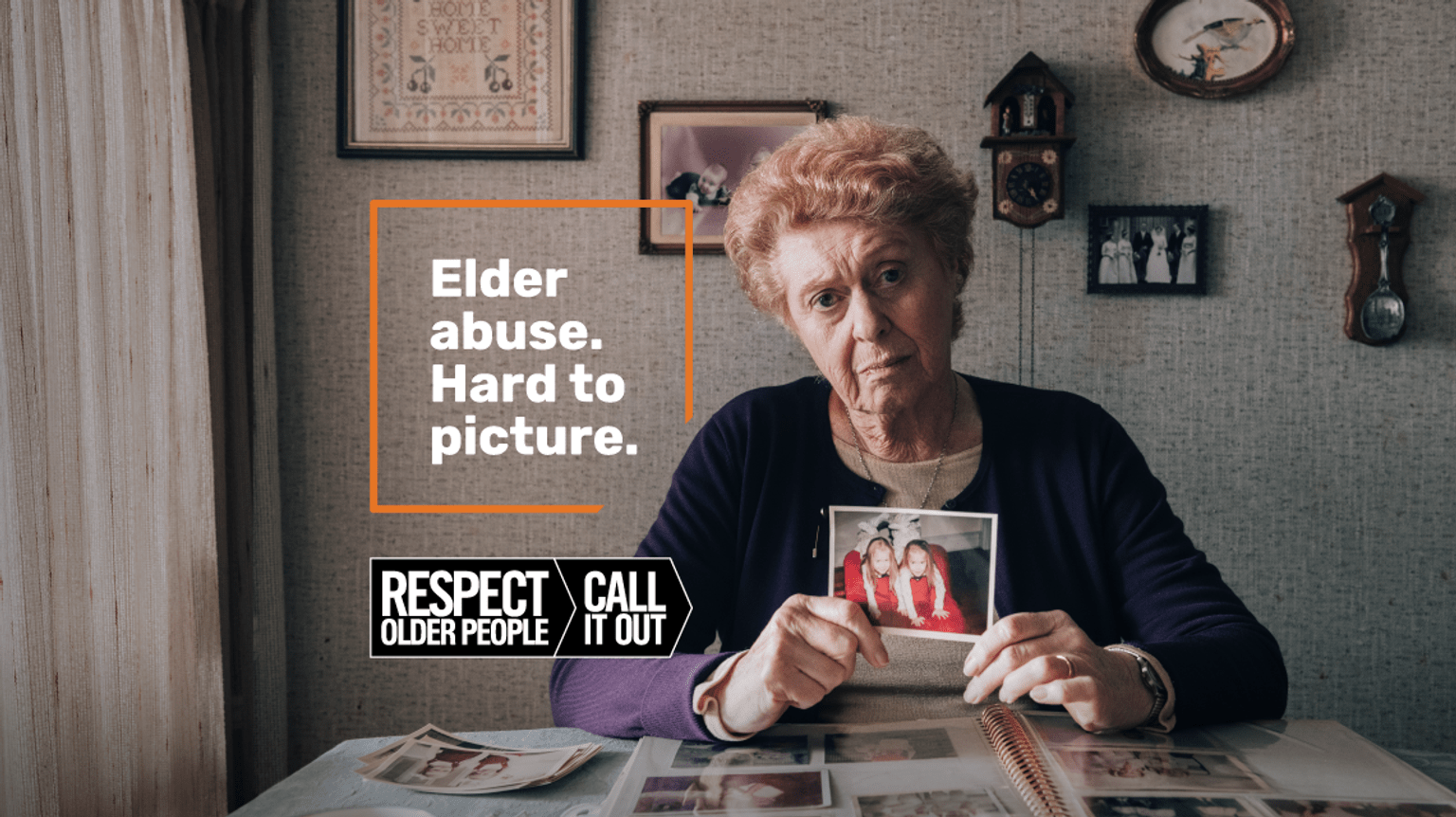 elderly-woman-looking-unhappy-holding-a-photograph-of-her-two-young-children-in-her-home-Text-reads-elder-abuse-Hard-to-picture.-Respect-older-people-Call-it-Out
