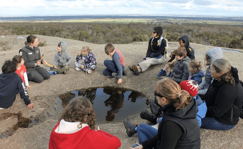 Our nature festival - Discovering Wadawurrung Photograph of a ranger and a diverse audience sitting high up in the country