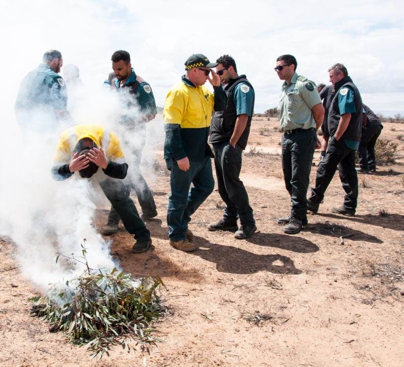 Managing Country Together with Traditional Owners Rangers around a smoking ceremony