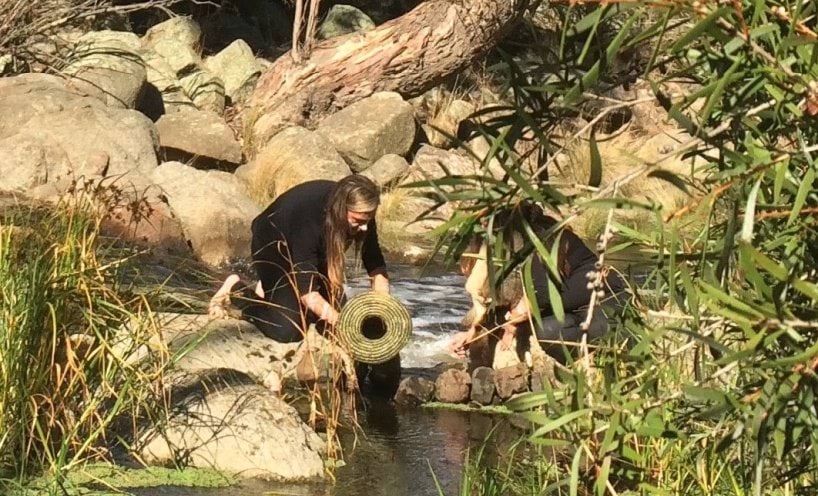 Tammy Gilson kneeling at river