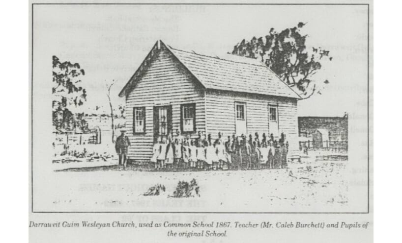 Children and teacher in front of timber church used as Darrweit Guim Common School in 1867.