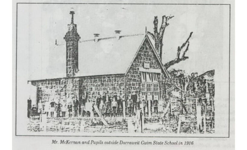 Teacher and children in front of Darraweit Guim State School stone building in 1916.