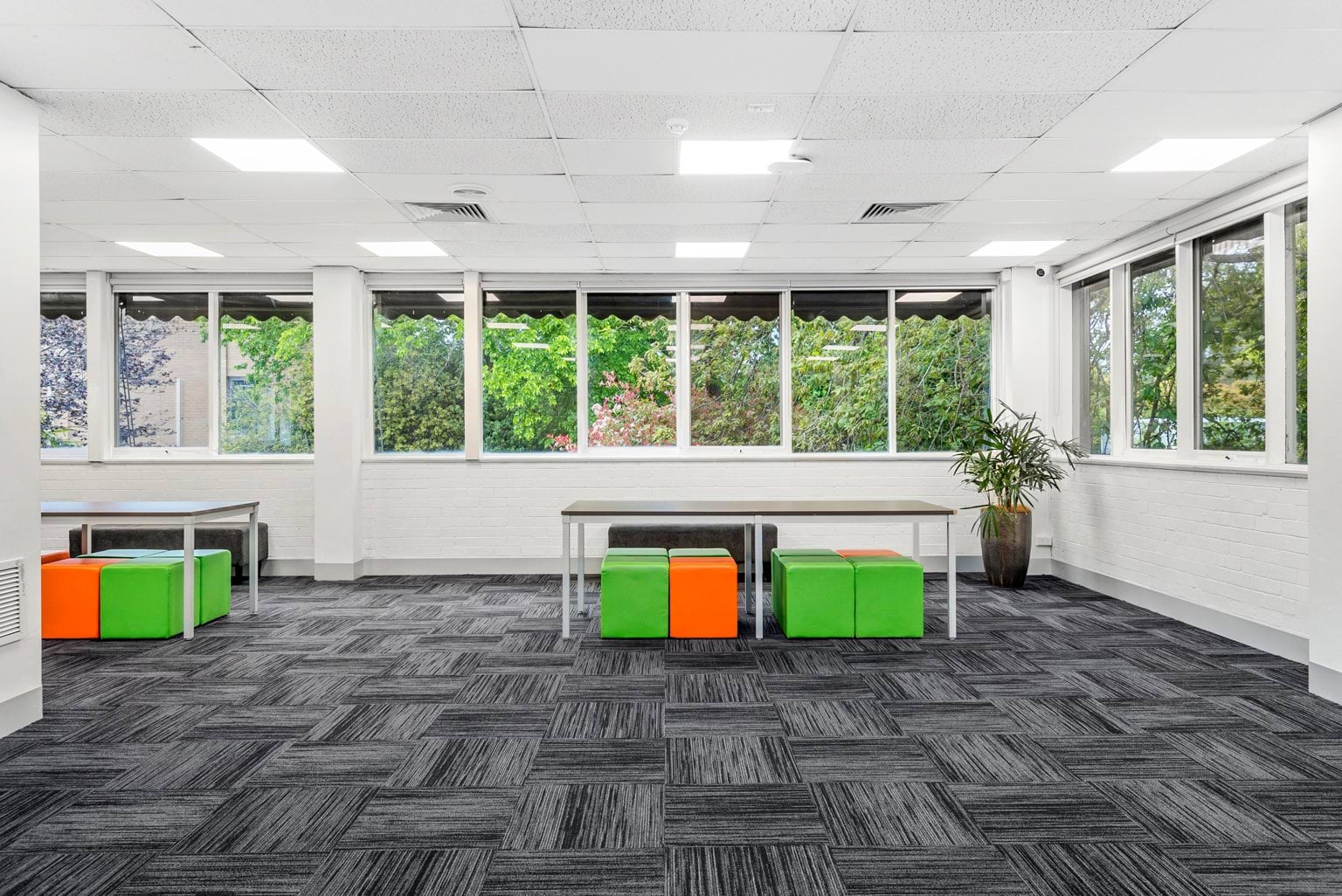 Image shows the Treetops meeting room at the VEMI Conference Centre with tables and chairs.