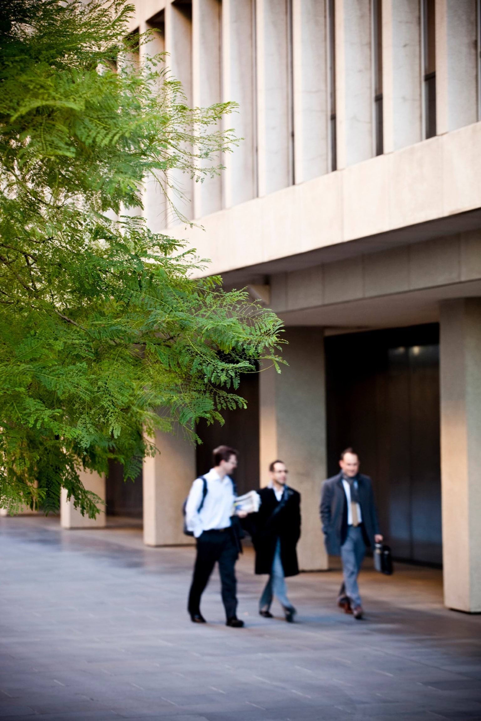 Image of three people walking in front of 1 Treasury place, Melbourne