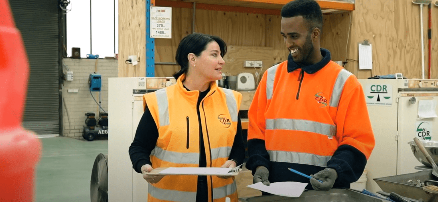 Male apprentice with employer at a construction worksite