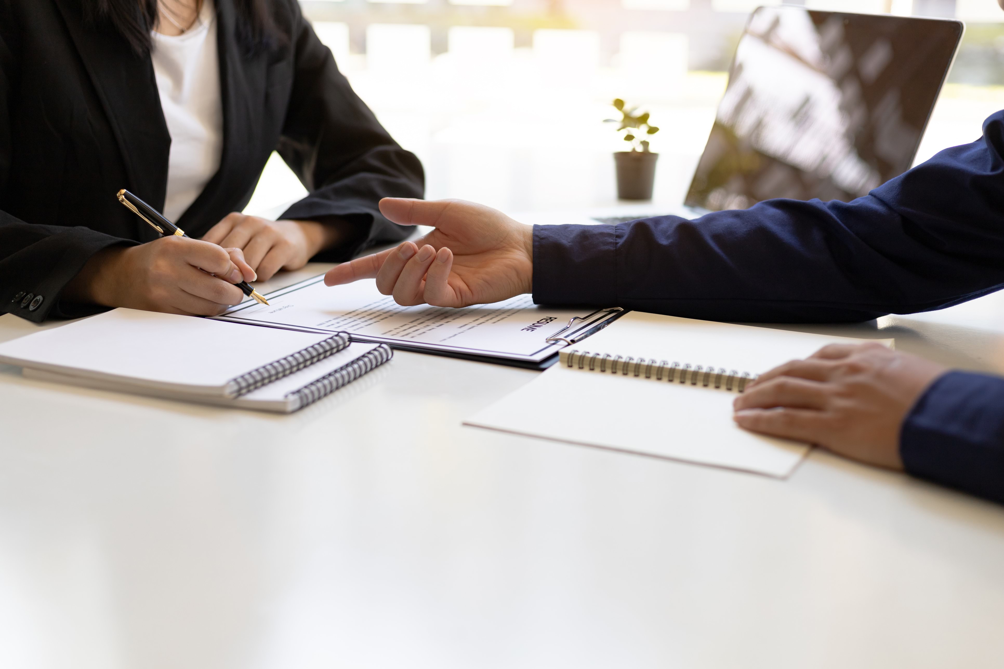 Two people engaging in a meeting across a table
