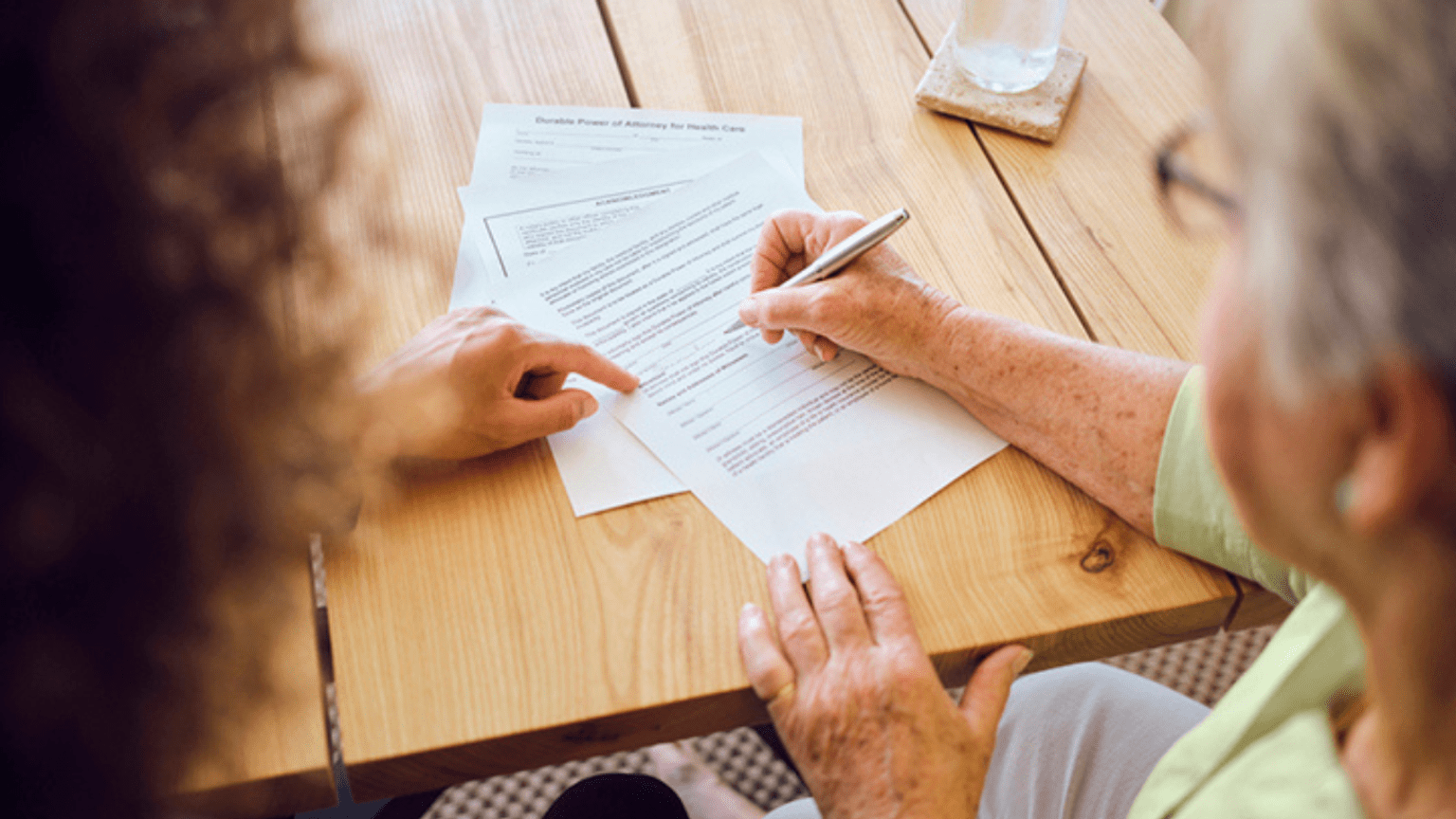 Two people filling out a form together