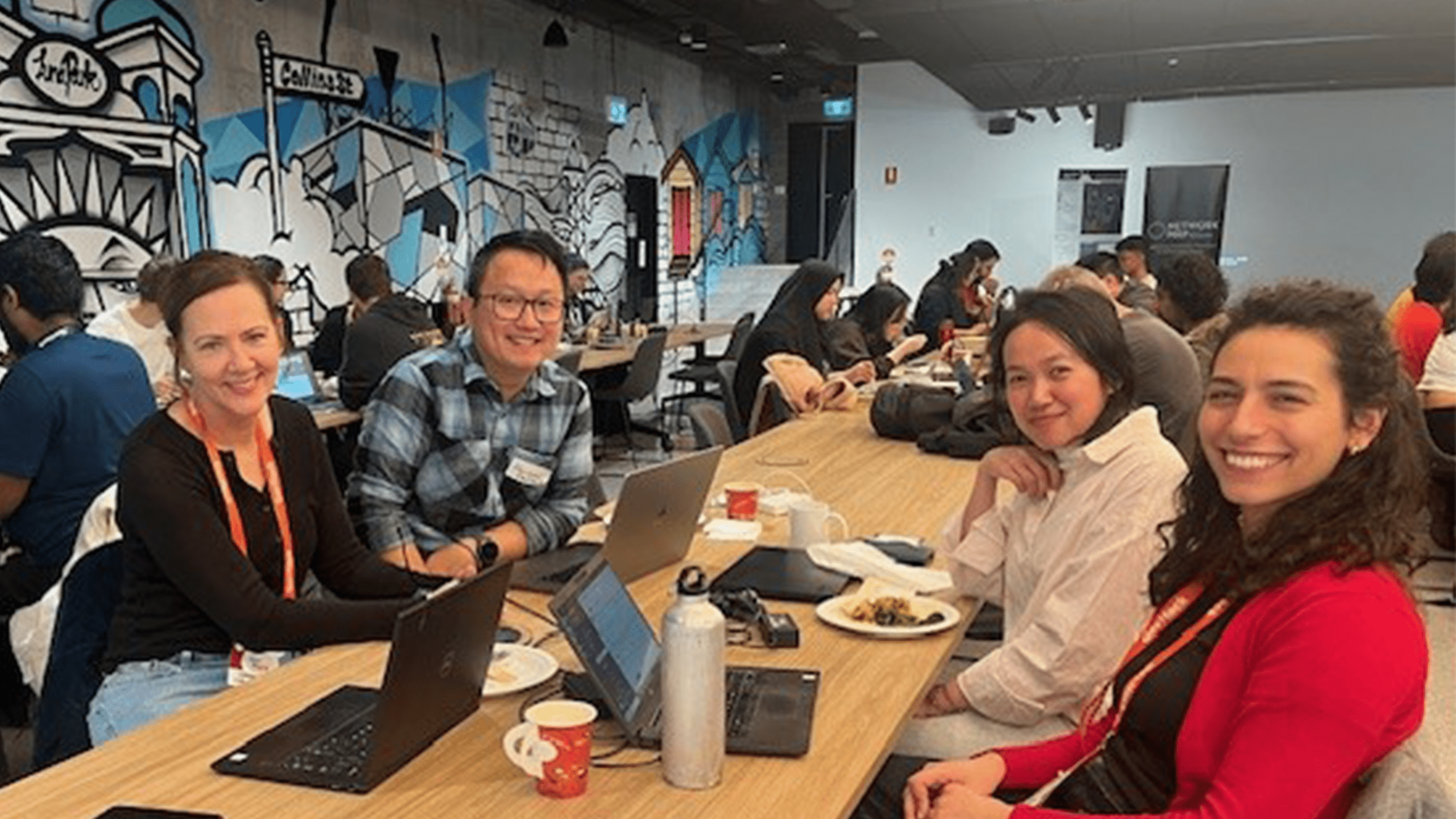 Four people sitting at a table at the GovHack event