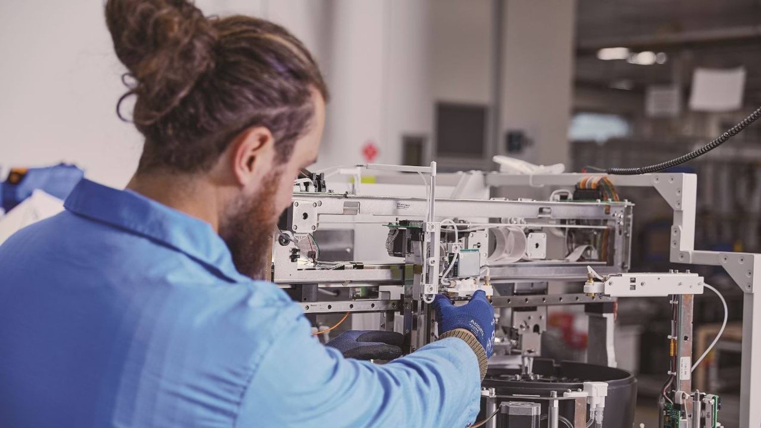 Person working with advanced medical equipment in a lab