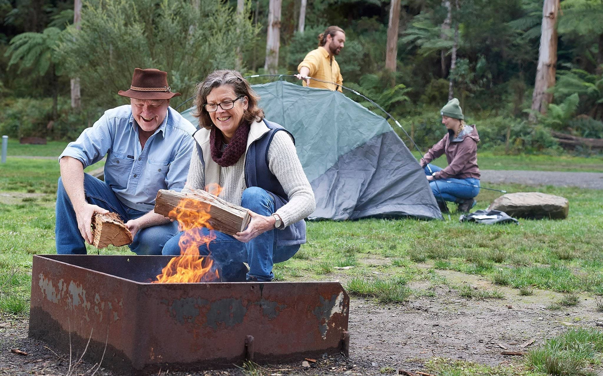 Campers building campfire