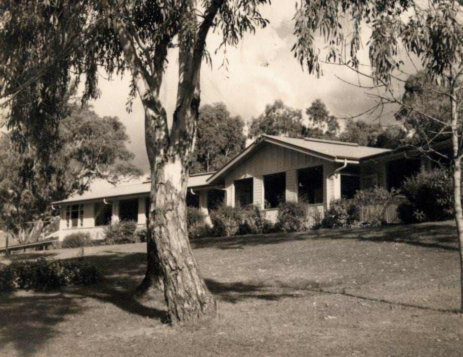 Sepia toned photo of Ward 11 of the Gresswell Sanitorium taken around 1940. There is a lawn in front with well established gum trees.