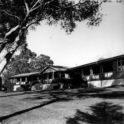 Sepia toned photo of the Gresswell Sanitorium, Wards 9 and 10, taken in the 1940s. It is a single storey brick building with a veranda.