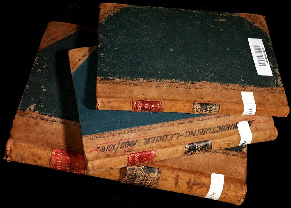 A stack of three historical record books for Sunbury Hospital.