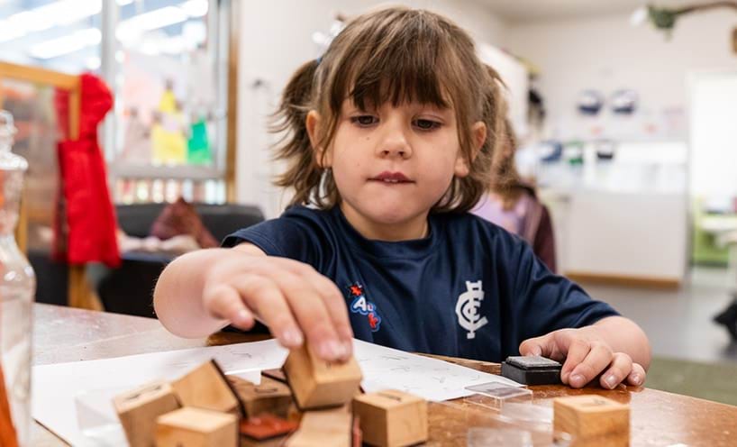 Child playing with wooden blocks