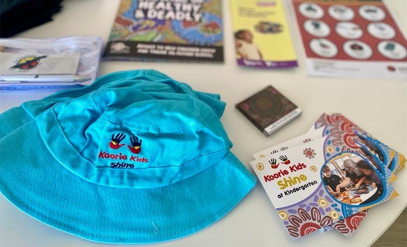 'Koorie Kids shine' hat and other preschool resources laid out on a table