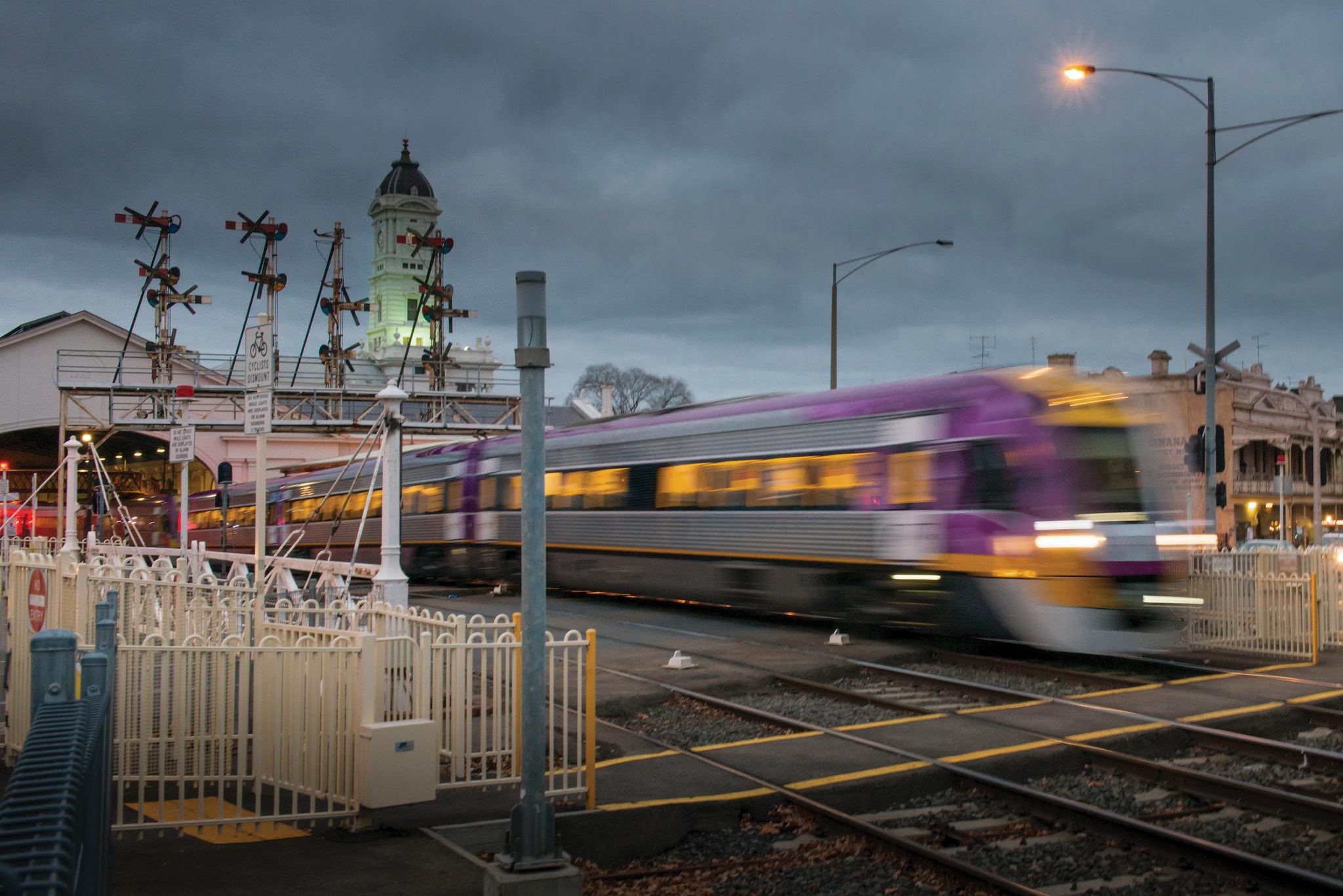 V/Line Train leaving Ballarat Station, passing over a level access pedestrian crossing.
