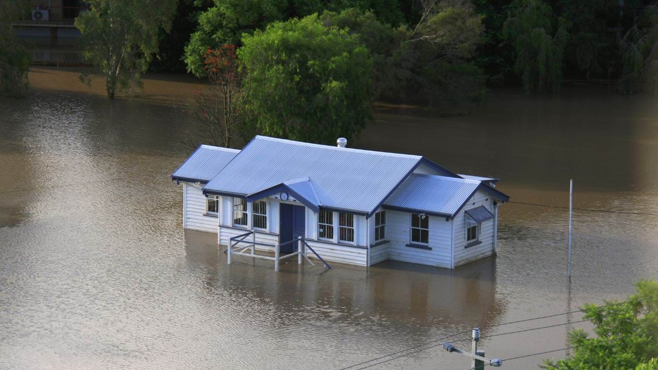 A flooded house surrounded by water