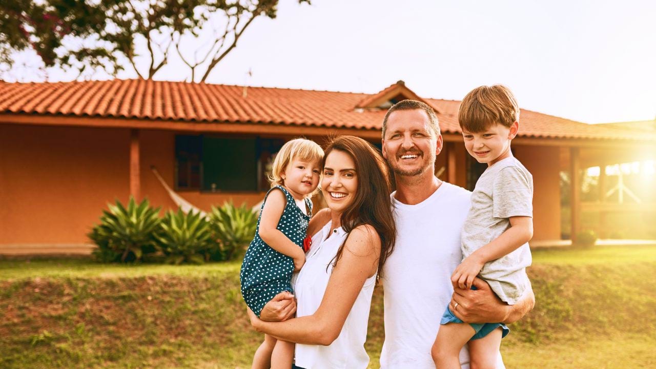 Family standing in front of their house
