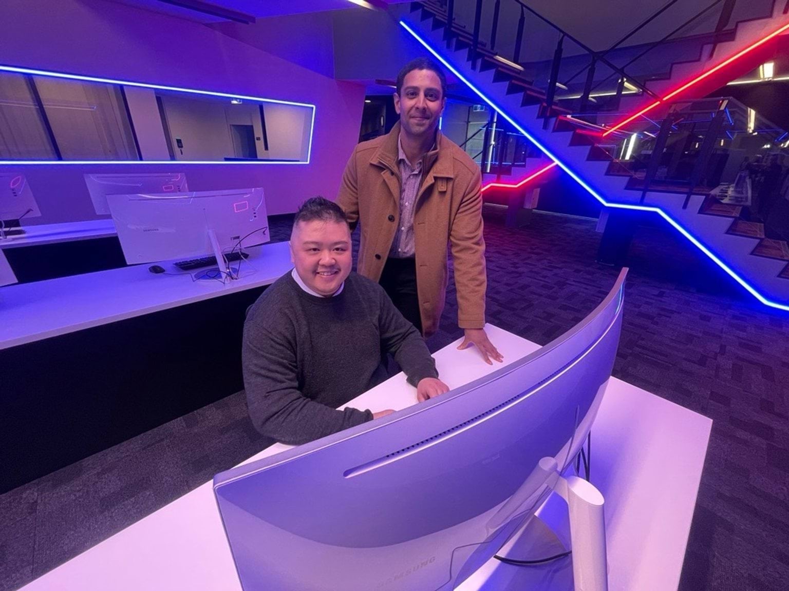 Two participants from the Victorian Government Cyber Internship Program 2025 in front of a computer.
