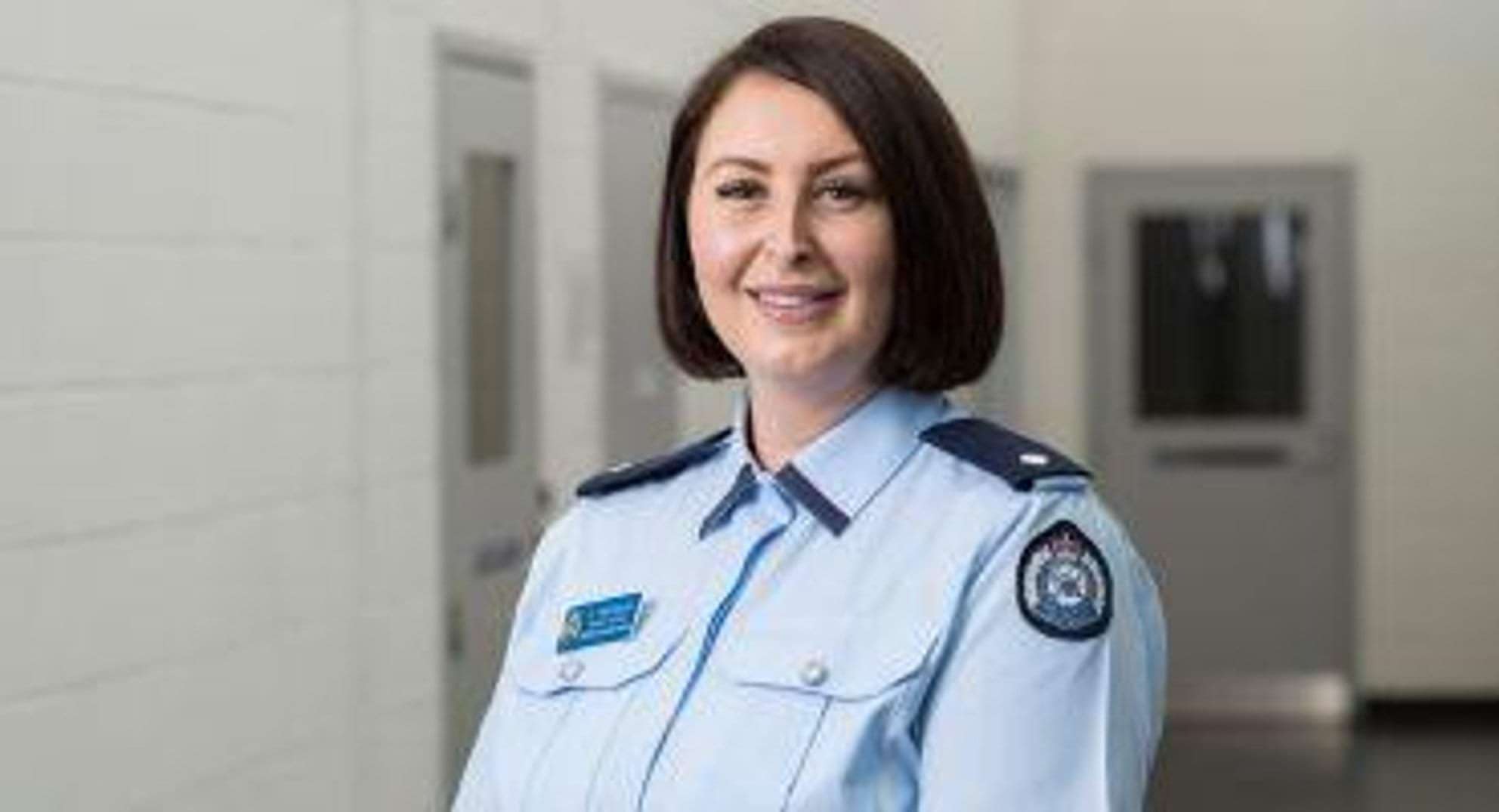 A smiling female prison officer