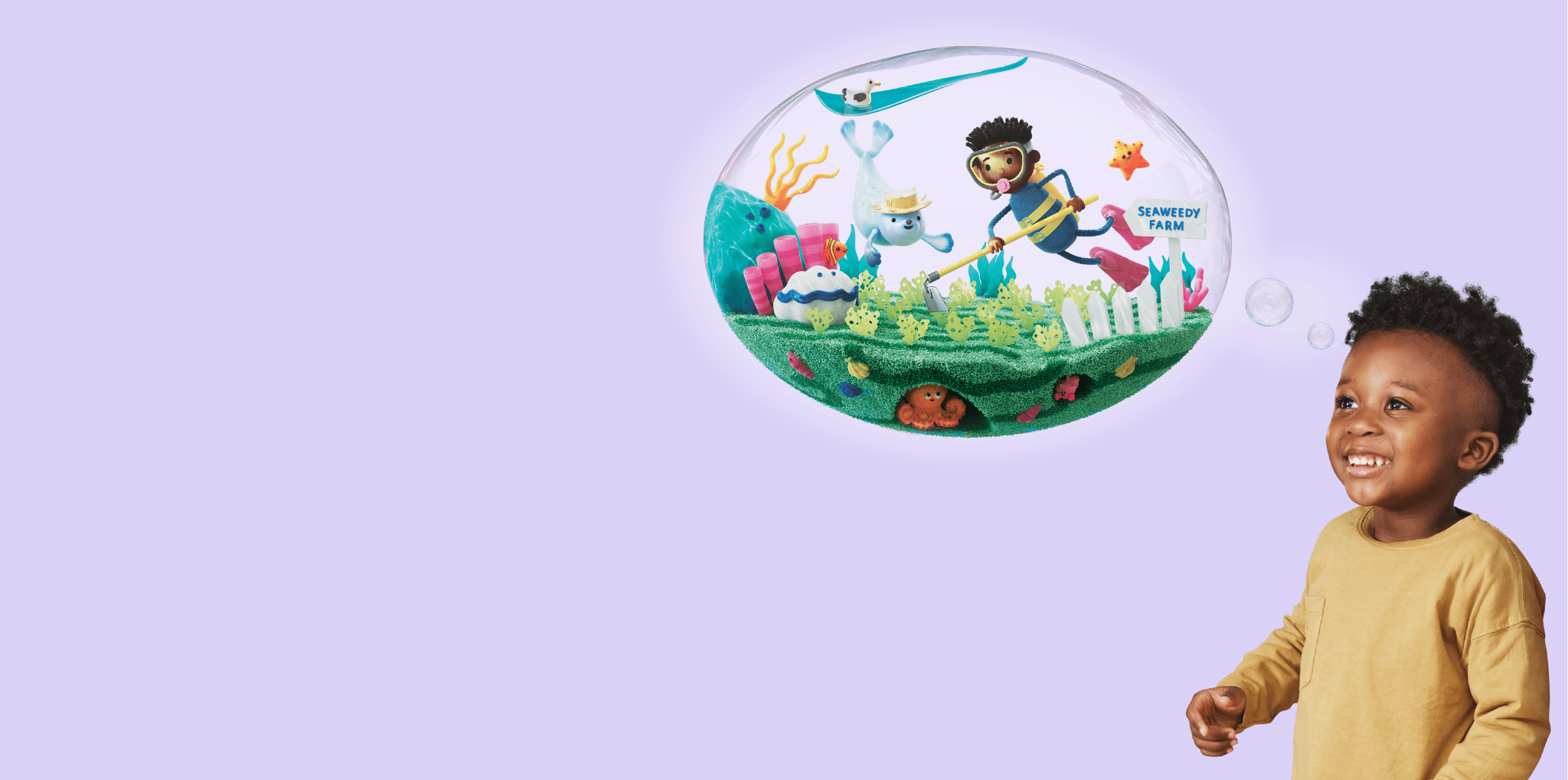 A smiling child looks up at a bubble showing an animated image of a person in a scuba suit gardening seaweed.
