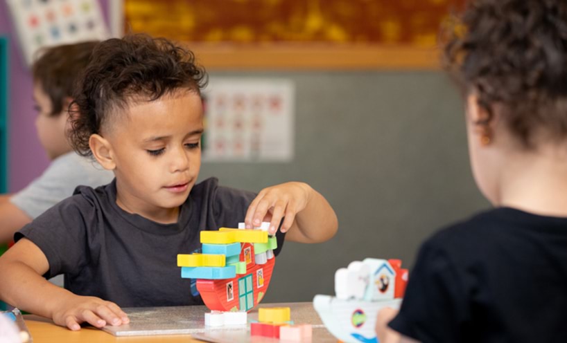 Two kids building with blocks
