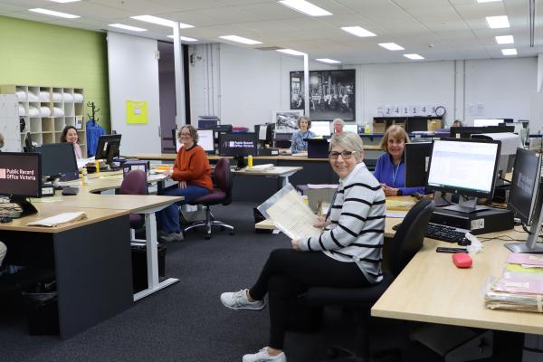 PROV volunteers working at computer desks in an open office setting.