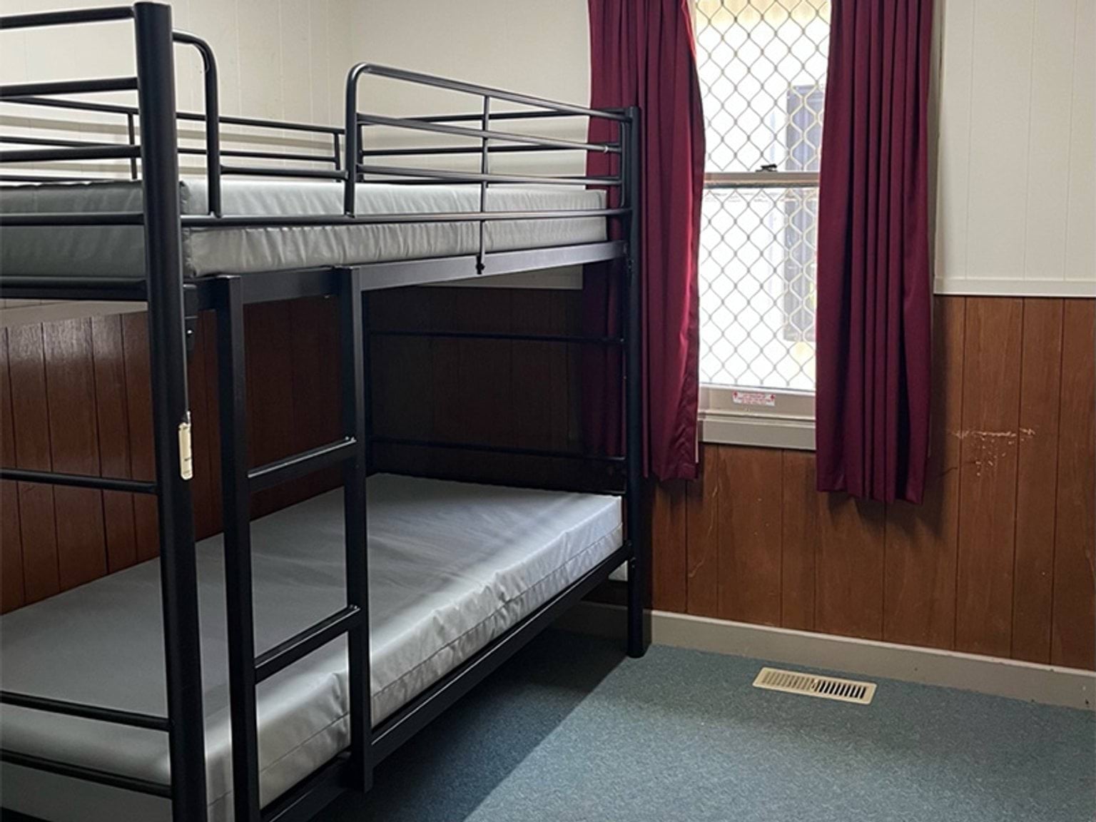 A bunk bed with 2 beds on top of each other for sleeping