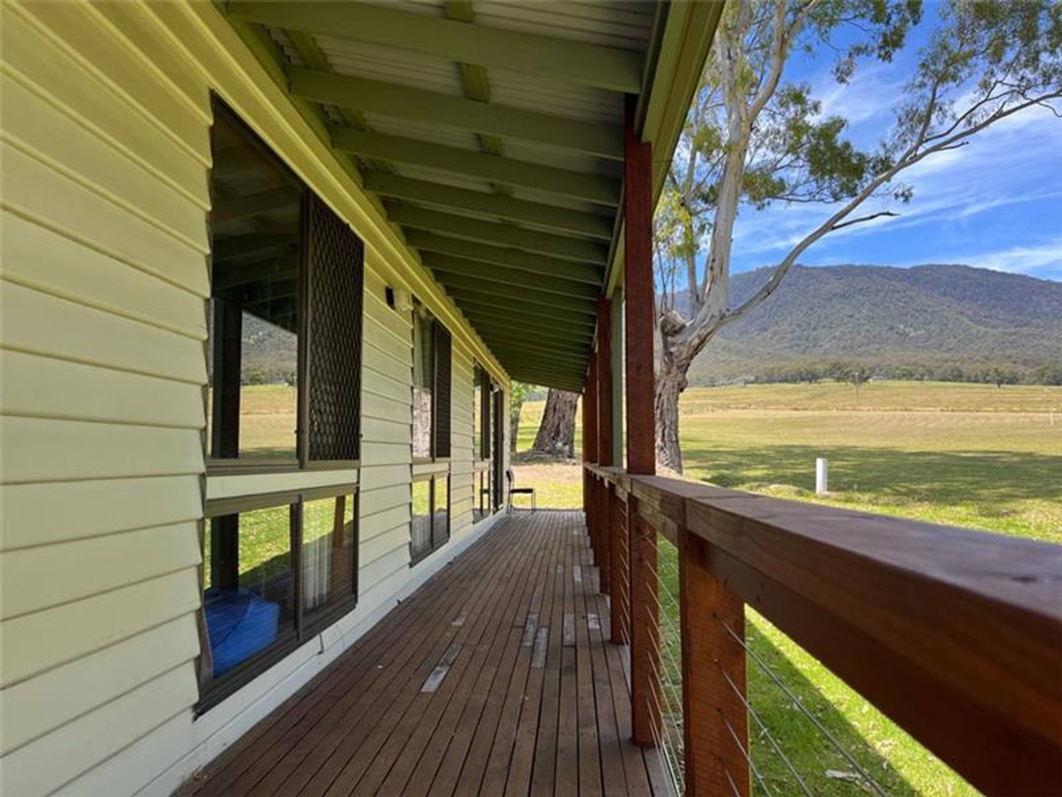 A deck connected to the building with bush land in the distance