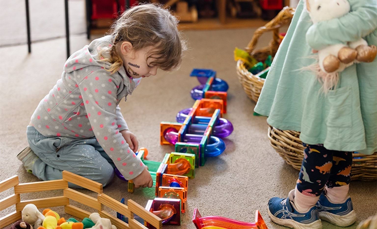 A child playing with magnetic educational building blocks