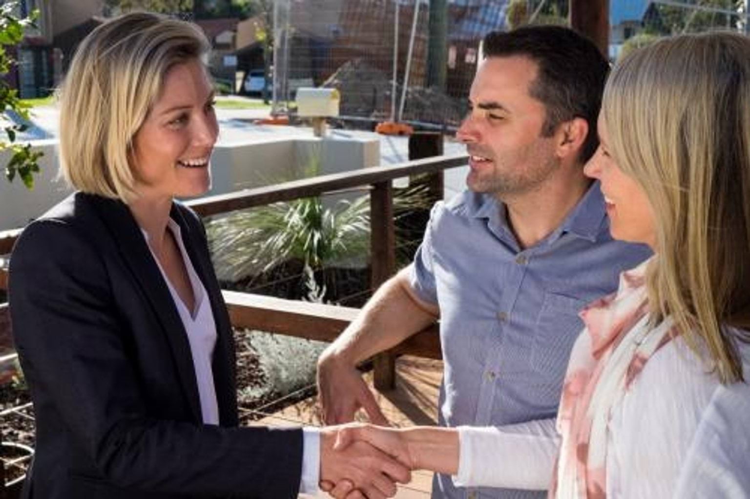 Woman estate agent talking to a couple