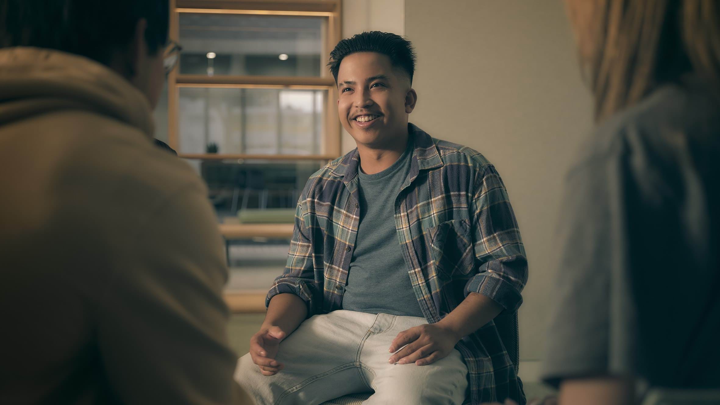 Nisha chatting to people in a group