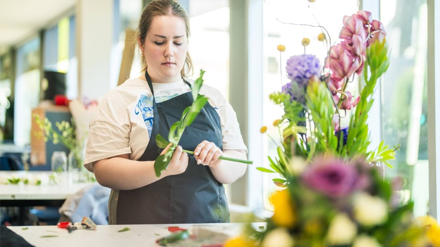 Student working on a flower arrangement at Box Hill Institute