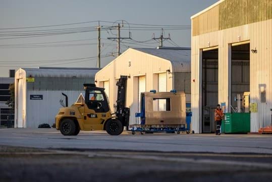 A forklift moves body panel parts of the new X'Trapolis 2.0 train