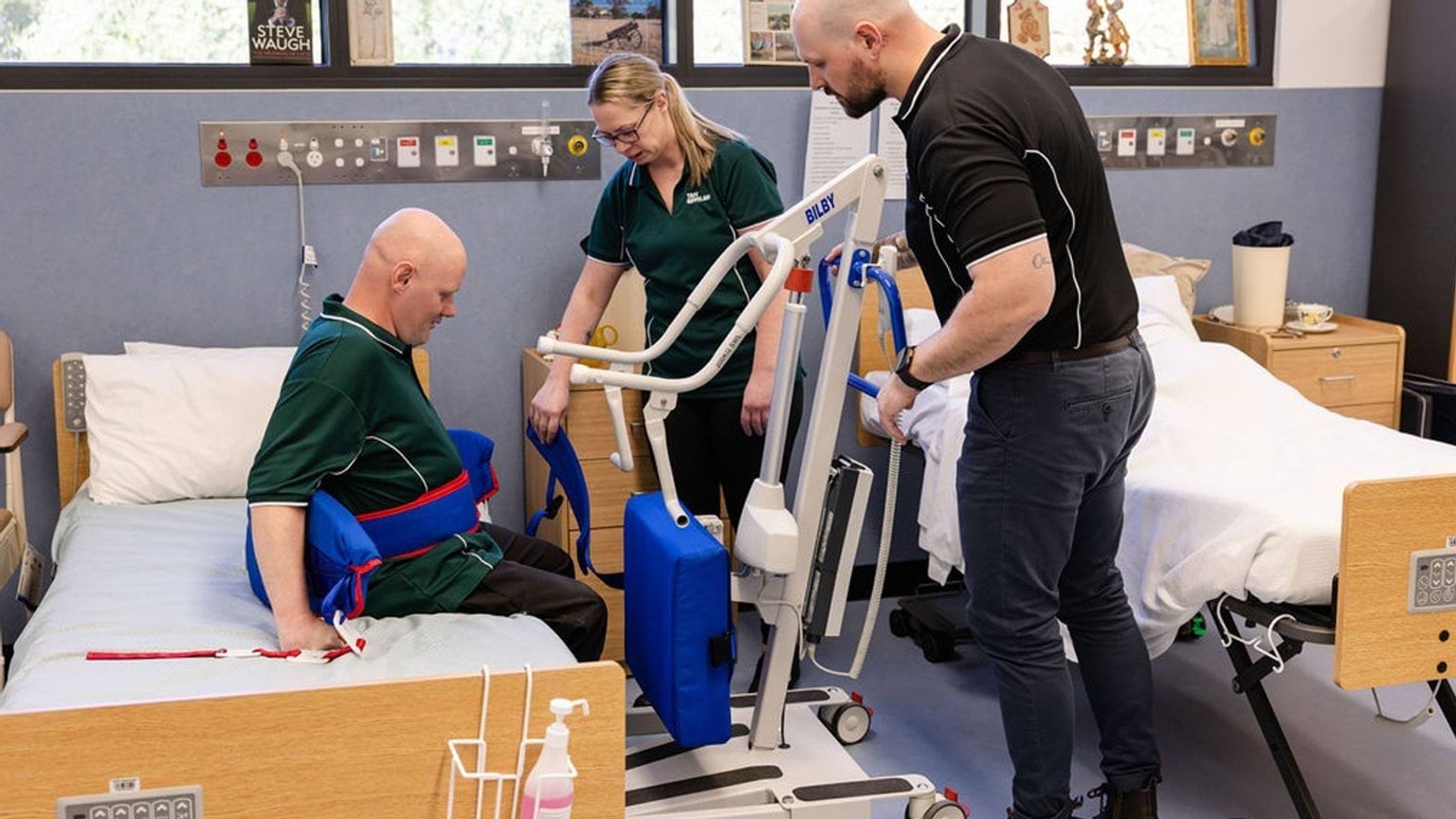 Students learn how to use equipment with a patient.