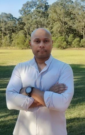 This image shows Australia Day Ambassador Mohammed Shabbir Alam OAM MStJ standing outside in nature