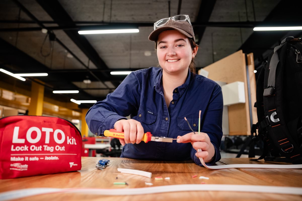 Female electrical apprentice at work