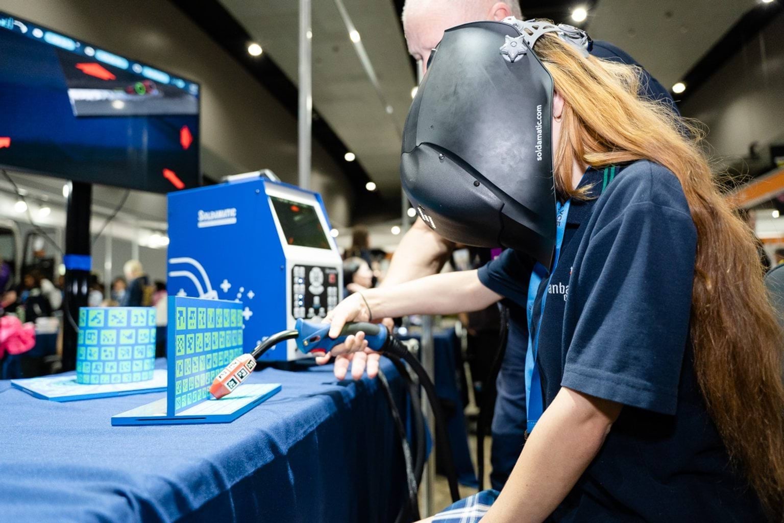 Female student at welding simulation