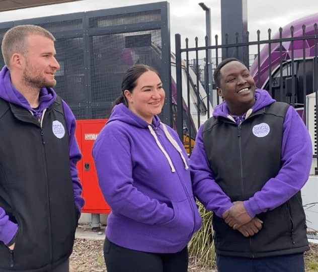 Community Connectors Kelly, Caitlin and Vinnie standing and posing for a photo outside Sunshine station.