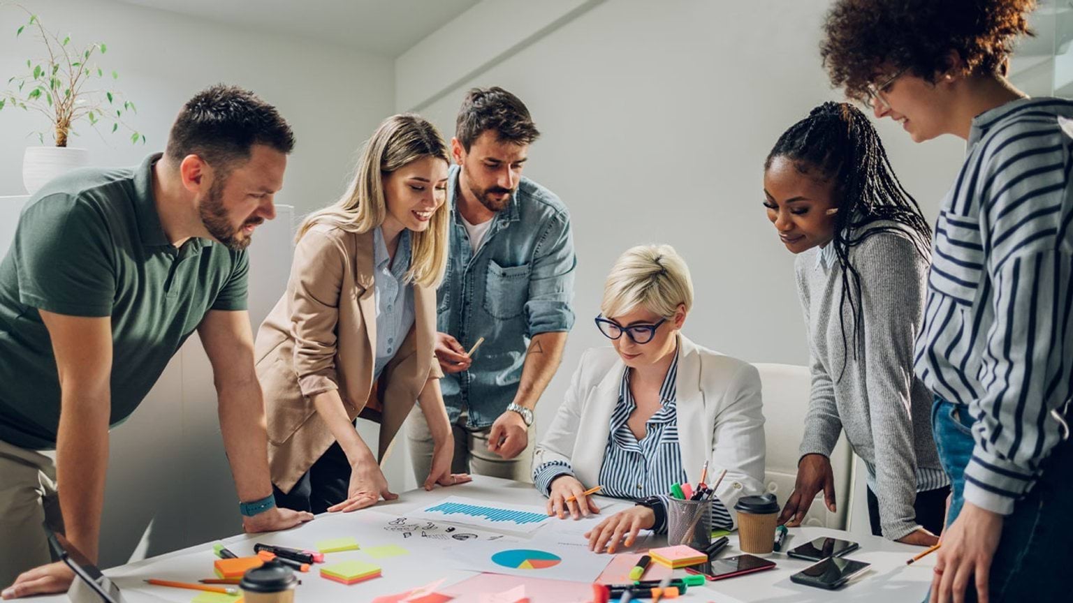 People standing around a table doing business planning