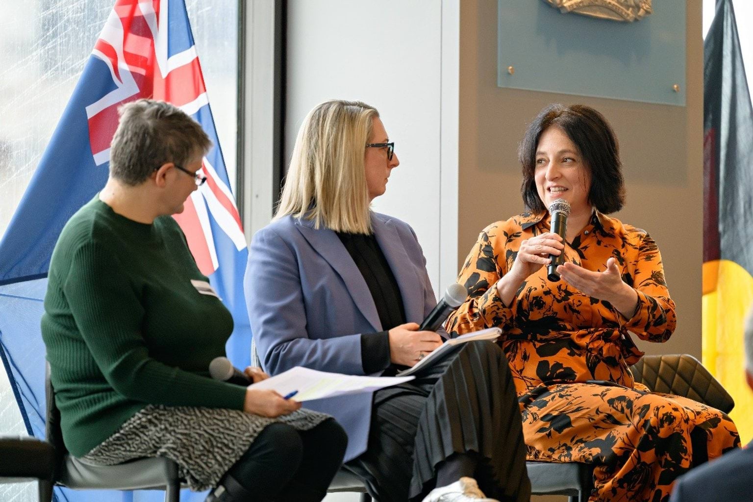 People sitting on a panel in active discussion 