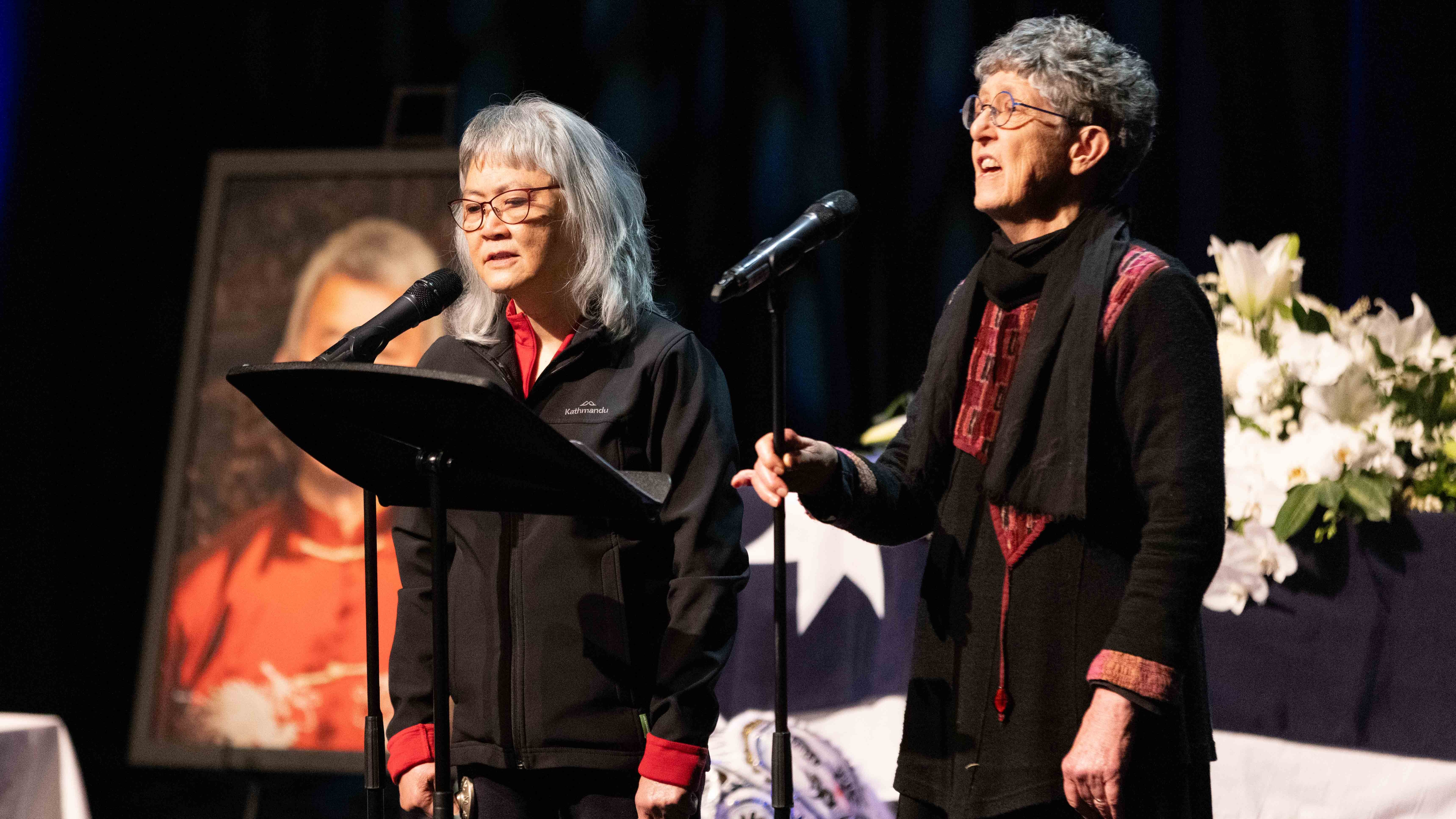 Lai Fong Low and Fay White perform The Pomelo Tree on stage at Russell's funeral