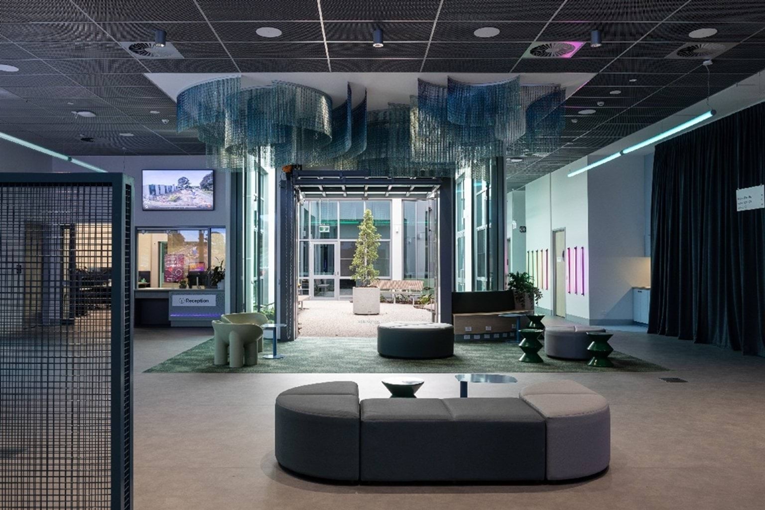 Reception area with seats and an outdoor space at Dandenong Tech School.