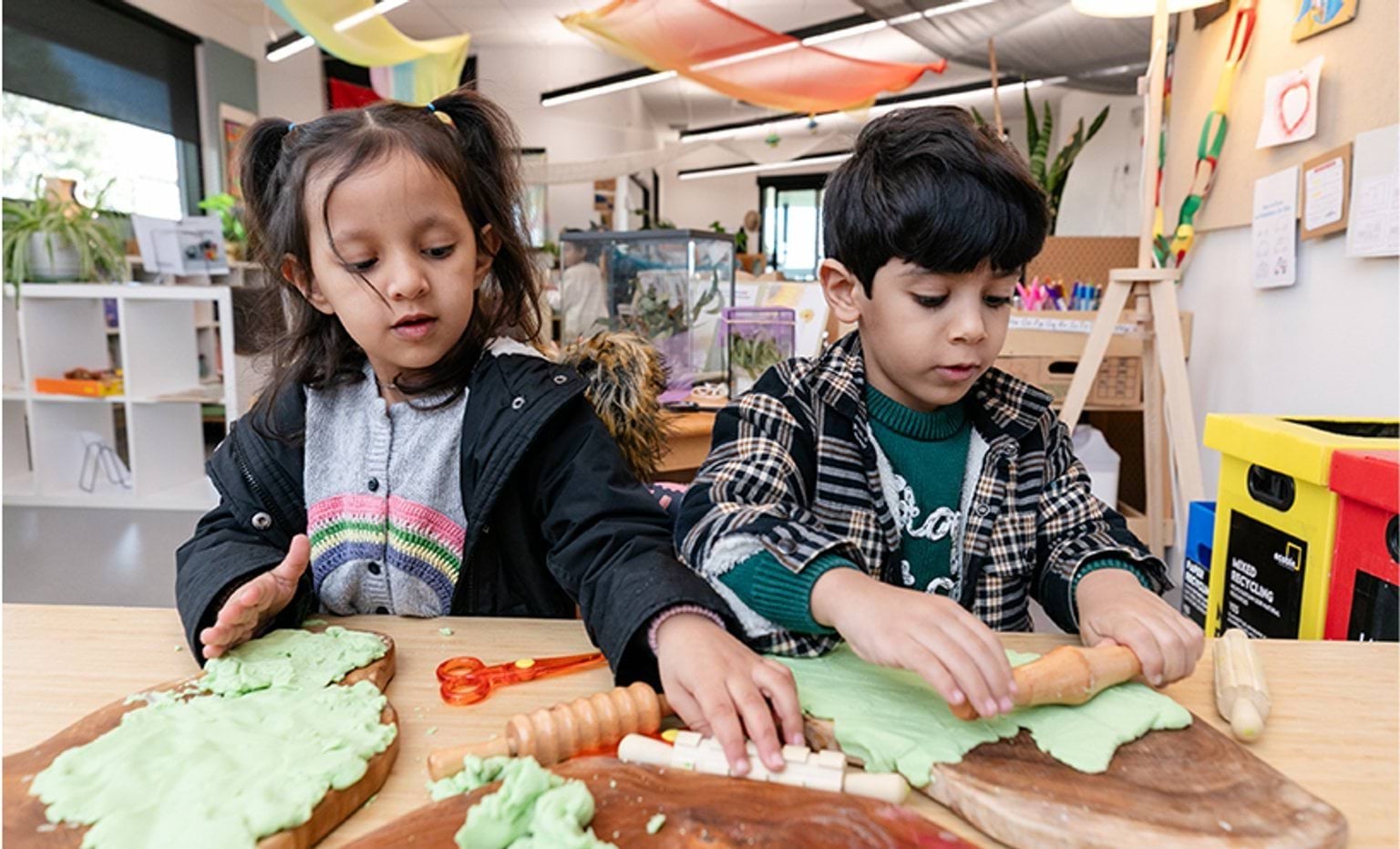 Two children playing with playdough.