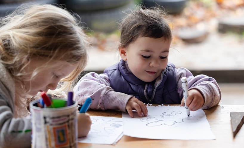 Two girls are drawing.